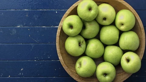 4k Time lapse of woman's hands choosing green apples out of wooden bowl until em Stock-Footage 199616620