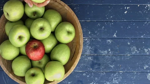 4k Time lapse of woman's hands choosing a red apple out of wooden bowl with gree Stock Footage 199616653