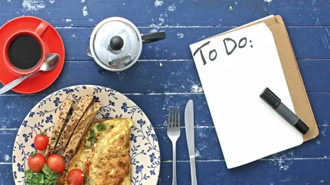 4k Time lapse of woman's hands preparing breakfast omelette and starting a list Stock Footage 199616909