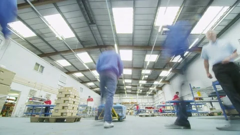 4K Time lapse of workers in factory warehouse moving pallets ready for shipping Stock Footage