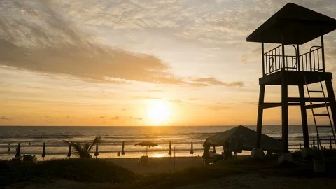 4K Time - lapse zoom out shot life guard tower on the beach with cloud moveme Stock Footage 82965679