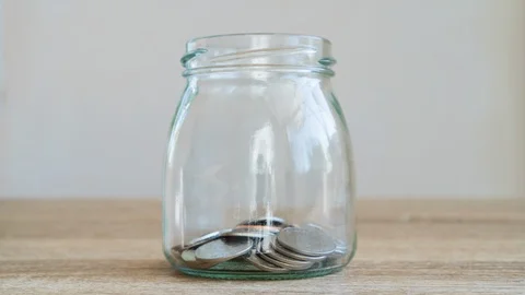 4K Time laspe or Stop motion Money savings concepts Put coins in glass bottle Stock Footage 128577006