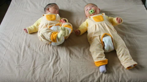 4k timelapse of 5 months old cute boy and girl twins babies lying and playing Stock Footage 61359389