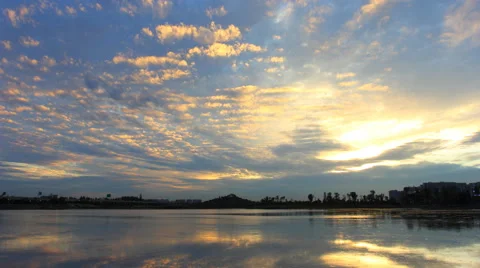 4k timelapse of beautiful sunset clouds over a lake Stock Footage 50534256