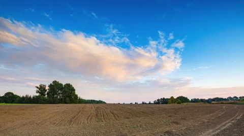 4k timelapse of beautiful sunset sky with clouds over plowed field. Stock Footage 58952853