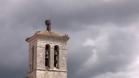 4k timelapse of the bell tower of a rural church with stork nests Stock Footage 180907716