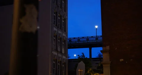 4K TIMELAPSE OF CLEAR NIGHT SKY WITH SUBWAY PASSING ON BRIDGE BETWEEN BUILDINGS Stock Footage 132080897