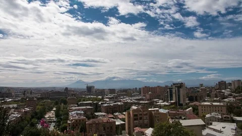 4K Timelapse of clouds above the city with huge mountain behind Stock Footage 81576415