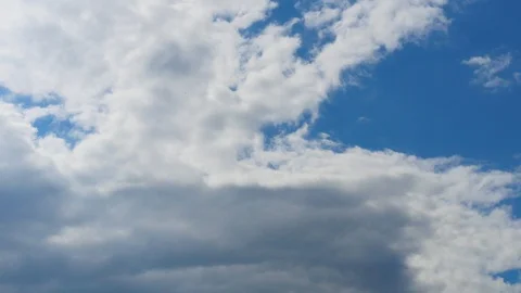 4K Timelapse - Clouds Against Blue Sky Stock Footage 128936619