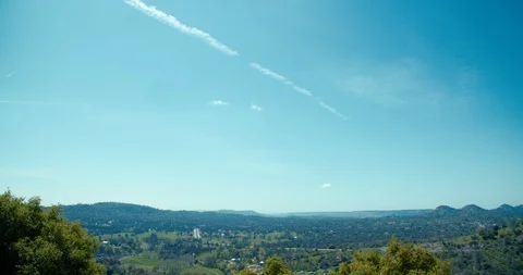 4K Timelapse of clouds forming over small town in valley Stock Footage 105492290