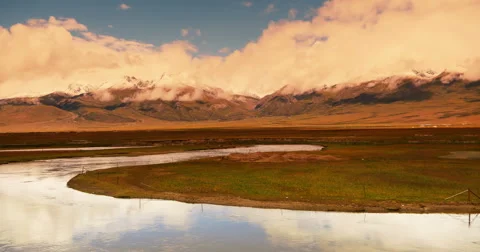 4k timelapse clouds mass rolling over Tibet mountain,River flowing the prairie. Stock Footage 45508236