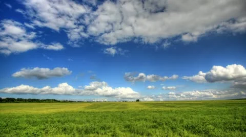 4K. Timelapse clouds over the green field. FULL HD, 4096x2304. Stock Footage