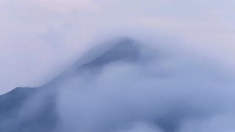 4K Timelapse Clouds rolling over mountain top at sunrise Stock Footage