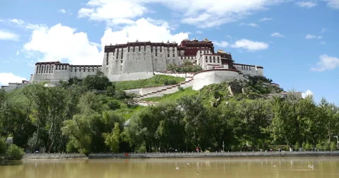 4k timelapse clouds rolling Potala in Lhasa,Tibet.lake with willow in lasa park Stock Footage 44727885