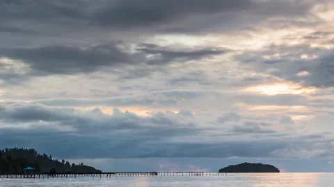 4K Timelapse, cloudy sunrise over the ocean, islands and wooden jetty Stock Footage 130432933