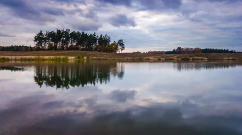 4k Timelapse of dark clouds over small lake Stock Footage 68958351