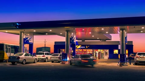 4K Timelapse. Day into night time, cars refuel at the gas station Gazpromneft Stock Footage