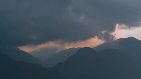 4K timelapse of dramatic mountain landscape and rain with dark clouds in sky at  Stock Footage 340338515