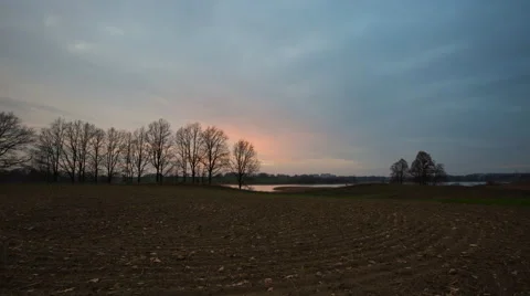 4k timelapse of evening sky over plowed field Stock Footage 60039488