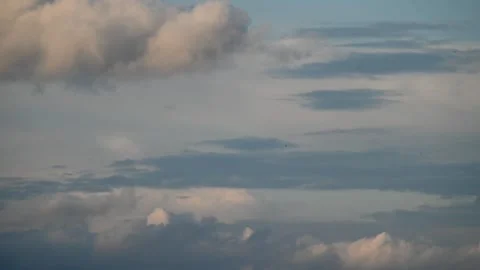 4K Timelapse of fast white clouds on blue sky just before sunset Stock Footage 247428892