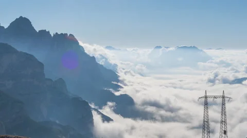 4k timelapse fog and clouds moving in the mountains, electrical poles Stock Footage 213609503