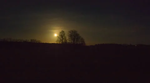 4k timelapse of full moving over plowed field and trees Stock Footage 60225738