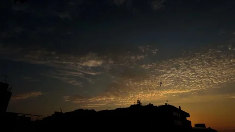 4K Timelapse of Golden Clouds Over Urban Skyline at Sunrise Stock Footage 341396508