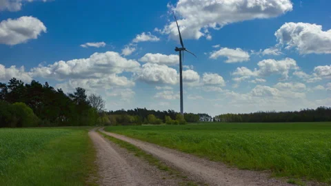 4k timelapse with green spring field, windmill and sandy road. Stock Footage 153651155