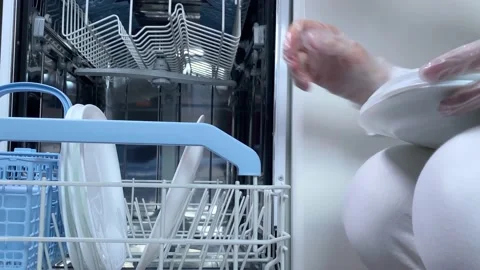 4k Timelapse. Hands putting white plates in dishwasher. Stock Footage 156513797