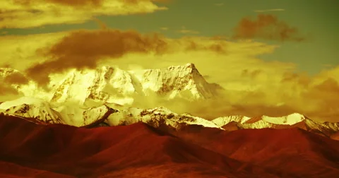 4k timelapse huge clouds mass rolling over lake namtso &amp; snow mountain in tibet Stock Footage 45618677