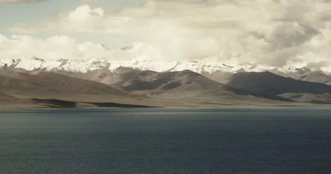 4k timelapse huge clouds mass rolling over lake namtso &amp; snow mountain in tibet Stock Footage 62473715