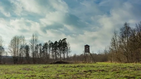 4k timelapse landscape with meadow and raised hide under fast moving clouds. Stock Footage 84459837