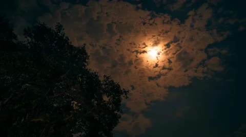 4K Timelapse - Light of the full moon is shining through moving clouds Stock Footage 67807104