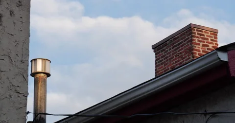 4K TIMELAPSE LONG SHOT DAY SKY AND CHIMNEY ON ROOF Video stock 131128949