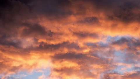 4K timelapse loops with dramatic orange sunset on dark cloudy sky Stock Footage 133707906