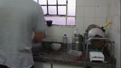 A 4k timelapse of a man doing dishwashing in his kitchen Stock Footage 131466890