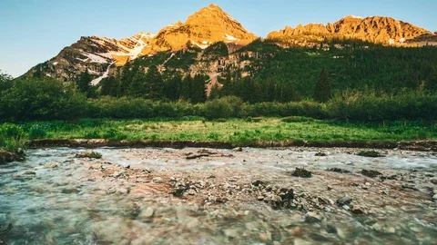 4K Timelapse of Maroon Bells mountains at sunrise with water stream  in Colorado Stock Footage 77630173