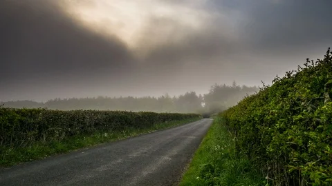 4K Timelapse Of Mist Rolling Over An English Country Road Stock Footage 91593944