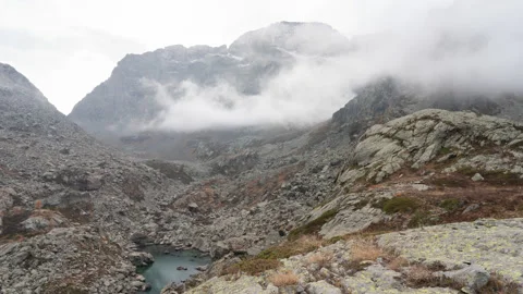 4K timelapse in the mountains, moving clouds, small lake, natural landscape Stock Footage 220020713