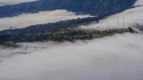 4K Timelapse of moving cloud over a village at Mount Bromo. Stock Footage 231733600
