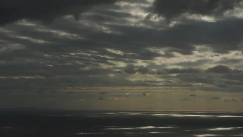 4K timelapse of moving clouds and shifting sunlight reflections over Aegean Sea, Stock Footage 329674688