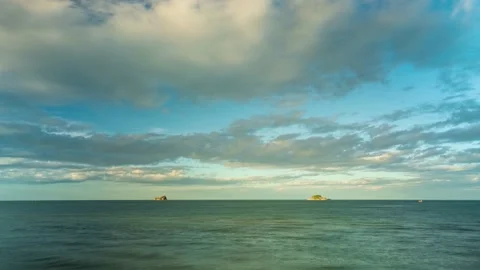 4K Timelapse of moving clouds over the sea with the islands and fisherman boats. Stock Footage 134516645