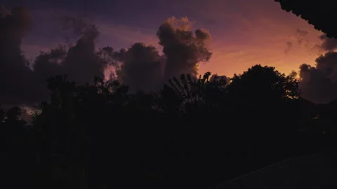 4K timelapse with orange cloudy sunset over tropic forest Stock Footage 264748310