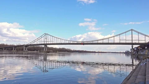 4K Timelapse of Pedestrian Bridge under the River Dnieper with Clear Blue Sky Stock Footage 74194250