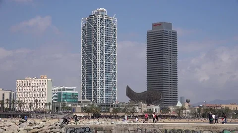 4K Timelapse people visit Olympic port promenade Barcelona golden fish sculpture Video stock 77737265