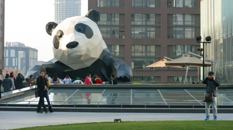 4k timelapse of people visit the statue of giant panda climbing on a building Stock Footage 45424845