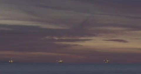 4k Timelapse of Pink Clouds On Ocean at Dusk with Oil Rigs Stock Footage 89136290