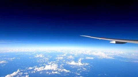 4K timelapse plane flying over clouds and ocean view from passenger side window Stock Footage 99618762