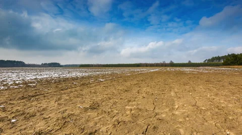 4k timelapse of plowed field under sky with clouds at early spring. Stock Footage 60993472