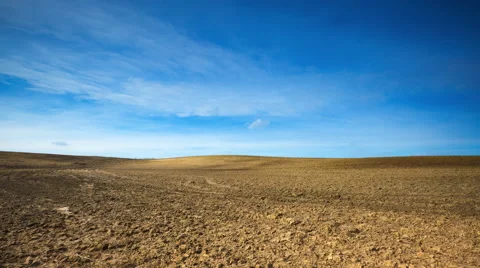 4k Timelapse of plowed field under blue sky with clouds Stock Footage 61113767